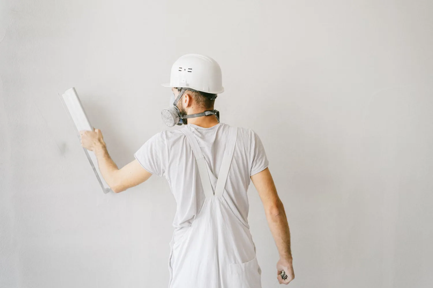Plasterer applying stucco to an exterior wall